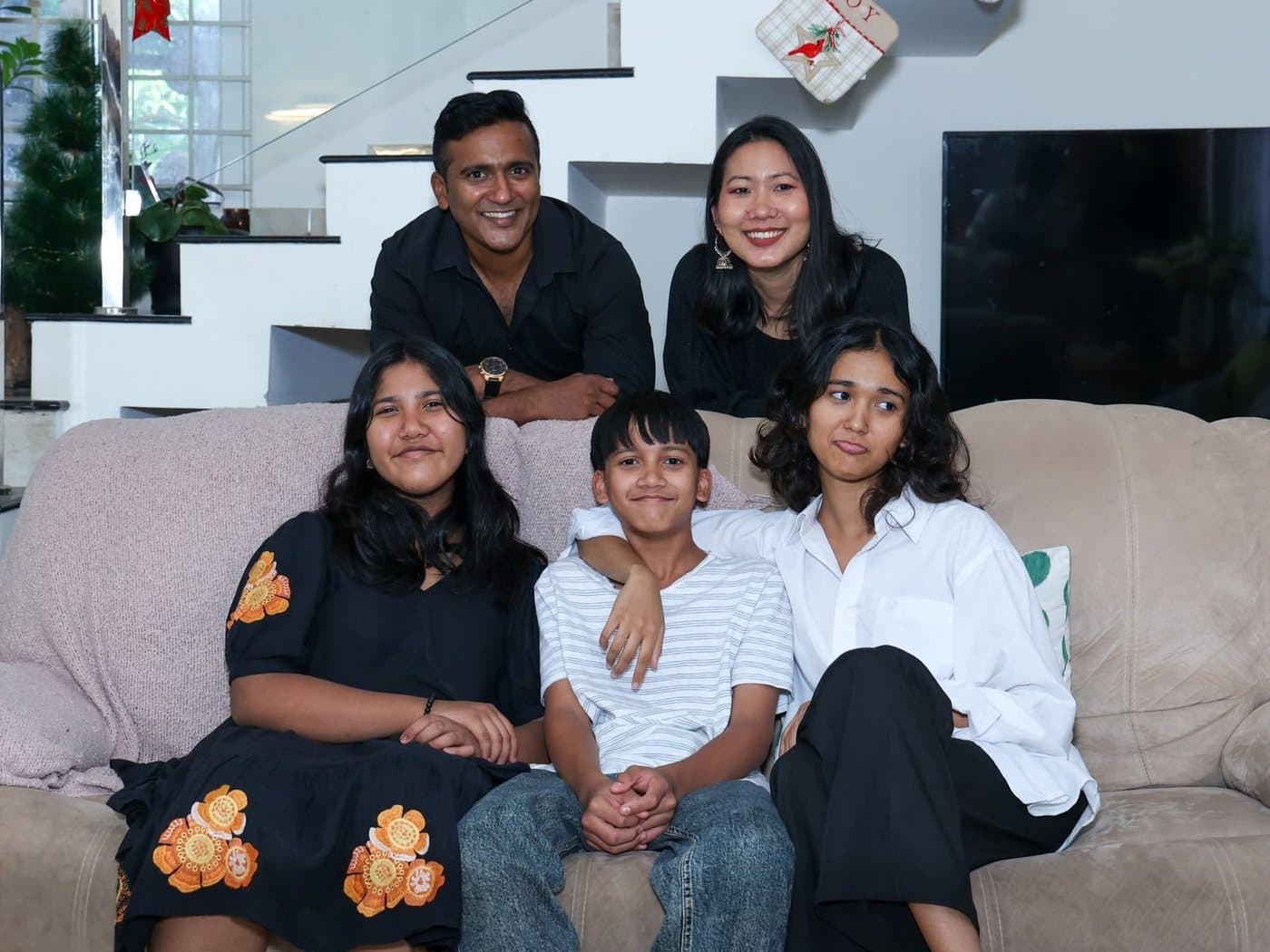 Joji Koshy Lalu with his wife Igwangheile and their three children at home